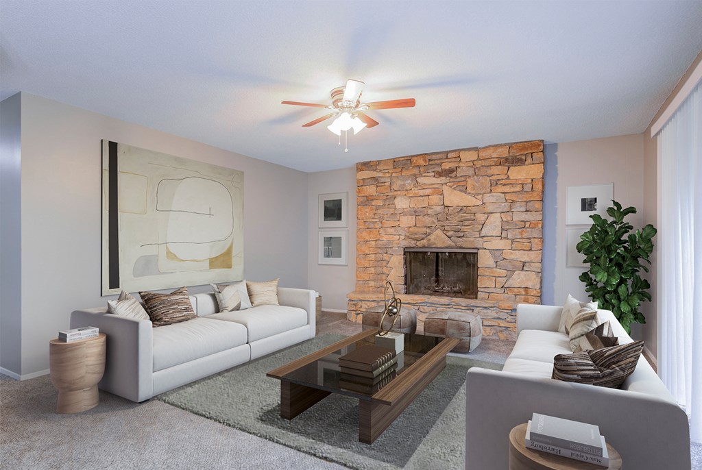a living room with a couch and a coffee table and a fireplace